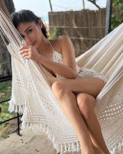 The Wives Actress Mouni Roy in a Boho Chic White Halter Style Crochet Bralette Crop Top with a Denim Shorts Photos 02