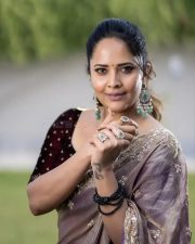 Tollywood Actress Anasuya Bharadwaj in a Muave and Silver Dual Tone Floral Butti Embroidery Saree with a Deep Wine Colored Velvet Blouse Pictures 03