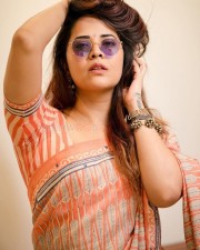 Tollywood Beauty Anasuya Bharadwaj in an Orange Saree and Puple Sunglass Photos 03