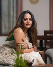 Tollywood Celebrity Anasuya Bharadwaj in an Off White Striped Saree with a Green Sleeveless Strap Blouse Photos 02