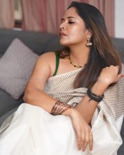 Tollywood Celebrity Anasuya Bharadwaj in an Off White Striped Saree with a Green Sleeveless Strap Blouse Photos 03