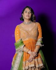 Wolf Actress Anasuya Bharadwaj in a Vibrant Orange Floor Length Anarkali Gown with a Green Organza Dupatta Photos 03