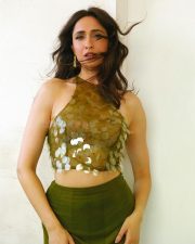 Attractive Pragya Jaiswal in a Sleeveless Halter Neck Embellished Top with a High Waisted Olive Green Sheer Skirt Photos 01