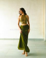 Attractive Pragya Jaiswal in a Sleeveless Halter Neck Embellished Top with a High Waisted Olive Green Sheer Skirt Photos 02