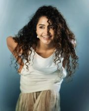 Beautiful Actress Anupama Parameswaran in a White Sleeveless Top with a Matching Flared Cotton Skirt Photos 02