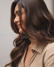 Charming Actress Mrunal Thakur in a Beige Wrap Shirt Blue Jeans Photos 02