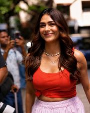 Charming Actress Mrunal Thakur in a Red Knotted Crop Top and Black Jacket Photos 02
