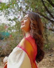 Charming Actress Mrunal Thakur in a pink and cream gradient colorblock oversized shrug with crop top photos 10