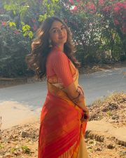 Charming Actress Mrunal Thakur in a pink and cream gradient colorblock oversized shrug with crop top photos 11