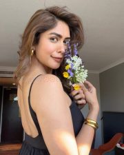 Charming Mrunal Thakur in a Black Spaghetti Strap Bodycon Dress Pictures 01
