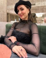Chic Actress Elli Avrram in a Black sheer mesh turtleneck and floral corset Photos 01