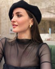 Chic Actress Elli Avrram in a Black sheer mesh turtleneck and floral corset Photos 04