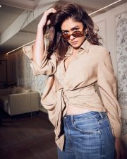 Chic Actress Mrunal Thakur in a Beige Wrap Shirt and Jeans Photos 01