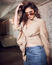 Chic Actress Mrunal Thakur in a Beige Wrap Shirt and Jeans Photos 01
