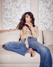 Chic Actress Mrunal Thakur in a Beige Wrap Shirt and Jeans Photos 03