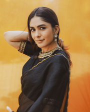 Elegant Actress Mrunal Thakur in a Black Gold Border Chiffon Saree Photos 04