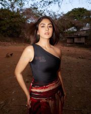 Glamorous Actress Mrunal Thakur in a black one shoulder top and red skirt Photos 03