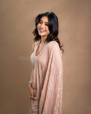 Graceful Actress Nabha Natesh in an ornate gold and magenta embroidered cream lehenga with gold jewelry photos 03