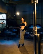 Impressive Nabha Natesh in a Black Tube Top with a Denim Skirt in a Car Garage Photos 02