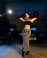 Impressive Nabha Natesh in a Black Tube Top with a Denim Skirt in a Car Garage Photos 03
