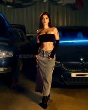 Impressive Nabha Natesh in a Black Tube Top with a Denim Skirt in a Car Garage Photos 05