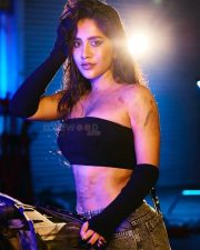 Impressive Nabha Natesh in a Black Tube Top with a Denim Skirt in a Car Garage Photos 08