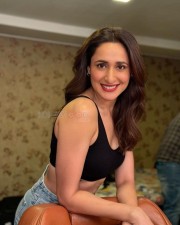 Ravishing Pragya Jaiswal in a Sleeveless Chick Blcak Top Blue Denim and Red Lipstick Photos 01