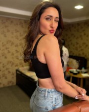 Ravishing Pragya Jaiswal in a Sleeveless Chick Blcak Top Blue Denim and Red Lipstick Photos 02