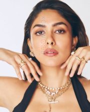 Sophisticated Actress Mrunal Thakur in a Black Halter Top with Layered Gold Jewelry Photos 03
