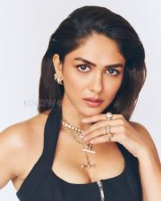 Sophisticated Actress Mrunal Thakur in a Black Halter Top with Layered Gold Jewelry Photos 06