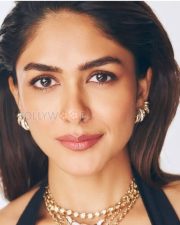 Sophisticated Actress Mrunal Thakur in a Black Halter Top with Layered Gold Jewelry Photos 08