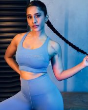 Striking Actress Nabha Natesh in a Blue Sports Bra Set Photos 03