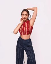 Stunning Pragya Jaiswal in a Red Sleeveless Crop Top and Denim Pants Photos 02