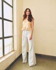 Stylish Actress Mrunal Thakur in a Peach Floral Ruffle Top And Jeans Photos 03