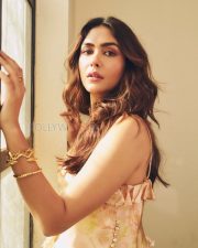 Stylish Actress Mrunal Thakur in a Peach Floral Ruffle Top And Jeans Photos 04