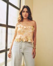 Stylish Actress Mrunal Thakur in a Peach Floral Ruffle Top And Jeans Photos 05