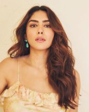 Stylish Actress Mrunal Thakur in a Peach Floral Ruffle Top And Jeans Photos 06