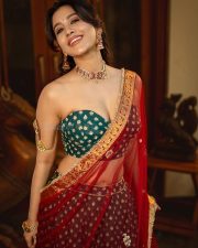 Swayambhu Actress Nabha Natesh in a Deep Bottle Green Lehenga with a Dark Green Strapless Sweetheart Neck Blouse and Sheer Dupatta Photos 01