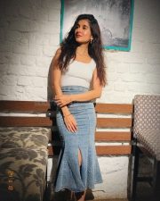 Varisu Actress Sanjana Sarathy in a White Sleeveless Top and Denim Skirt Photos 02