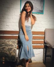 Varisu Actress Sanjana Sarathy in a White Sleeveless Top and Denim Skirt Photos 03