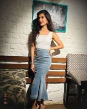 Varisu Actress Sanjana Sarathy in a White Sleeveless Top and Denim Skirt Photos 04