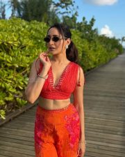 Vibrant Actress Pragya Jaiswal in a Red Crop Top Orange Floral Pants Photos 01