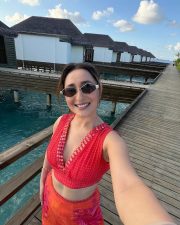 Vibrant Actress Pragya Jaiswal in a Red Crop Top Orange Floral Pants Photos 04