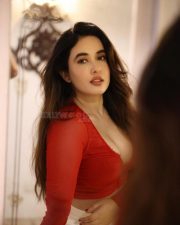 Hot Nepali Model Aditi Budhathoki in a Red Mesh Long Sleeved Crop Top with a White High Waisted Jeans Photos 02