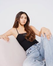 Innocent Beauty Radhika Seth in a Black Spaghetti Top and Blue Jeans Photos 01