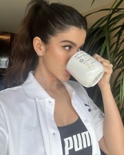 Sexy Shanaya Kapoor Drinking in a White Shirt and Puma Top Photos 02