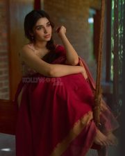Beautiful Telugu Actress Krithi Shetty in a Maroon Red Silk Saree with a Cream Sleeveless Blouse Pictures 02