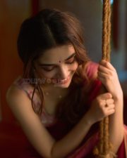 Beautiful Telugu Actress Krithi Shetty in a Maroon Red Silk Saree with a Cream Sleeveless Blouse Pictures 03