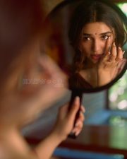 Beautiful Telugu Actress Krithi Shetty in a Maroon Red Silk Saree with a Cream Sleeveless Blouse Pictures 05