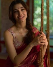 Beautiful Telugu Actress Krithi Shetty in a Maroon Red Silk Saree with a Cream Sleeveless Blouse Pictures 06
